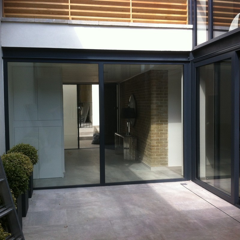 Floor-to-ceiling sliding doors opening to courtyard in Friern Barnet