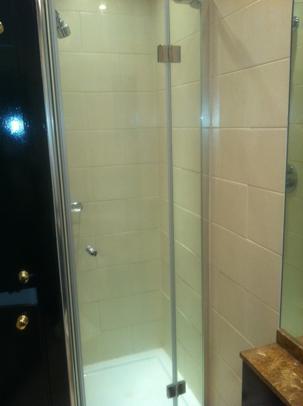 Frameless glass shower enclosure with chrome fittings in Friern Barnet