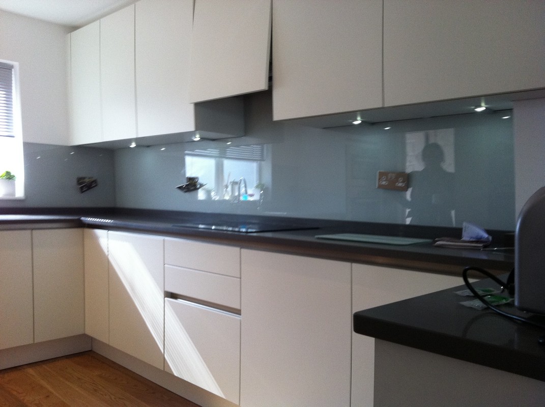 Grey glass kitchen splashback with LED lighting in Friern Barnet
