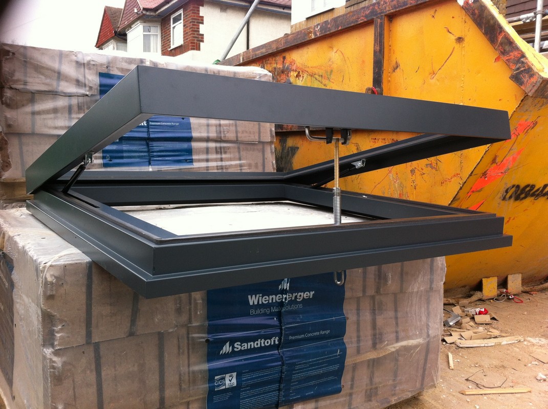 Opening flat roof skylight in anthracite grey installed in Friern Barnet
