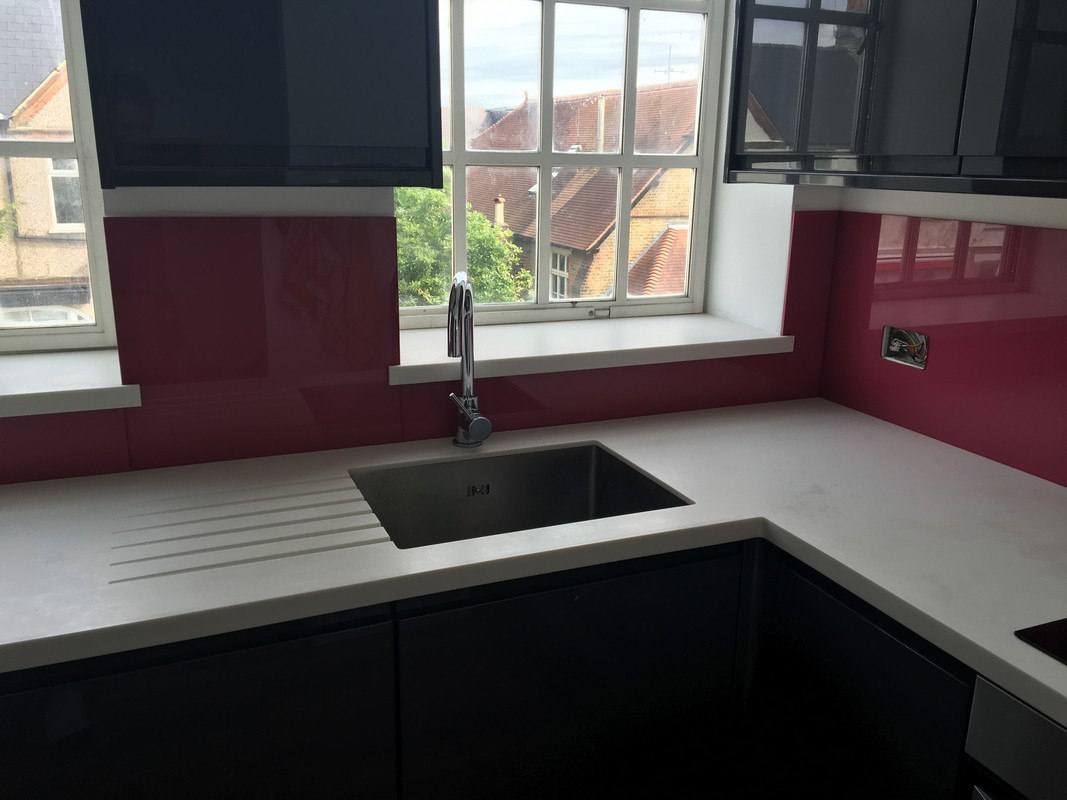 Deep plum coloured glass splashback in modern Friern Barnet kitchen